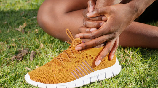 Person holding heel with foot pain - How long does plantar fasciitis take to heal