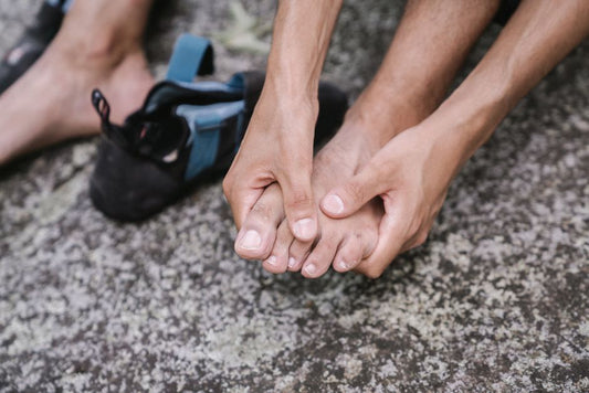 Person rubbing their sore bare foot for relief at home
